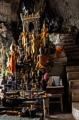 Luang Prabang, Laos - The Pak Ou Caves, the lower cave called Tham Ting. The caves, a Buddhist pilgrimage site, are a repository of old Buddha statues. 